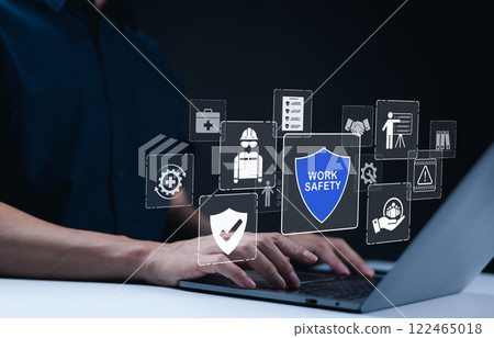 Work safety and compliance concepts. Businessman typing on laptop with virtual icons representing work safety, compliance, and security, workplace safety, and regulatory adherence. Safety first 122465018