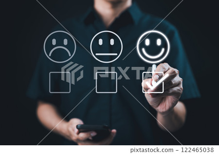 Customer satisfaction and feedback survey concept. A person select happy face, indicating positive feedback in customer satisfaction survey. customer experience evaluation and feedback collection. 122465038