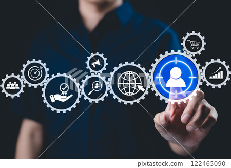 Digital marketing strategy and customer targeting concept. A person interacts with interface marketing and customer target icons, symbolizing strategic planning, audience engagement, business growth, 122465090