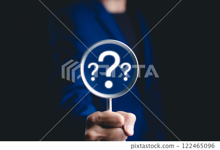 Question mark, Problem solving and analysis concept. Businessman holds magnifying glass focused on question mark, analysis, problem solving, identifying cause of issues during work process, solution, 122465096