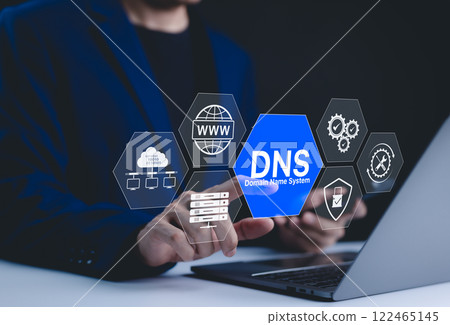 DNS domain name system and web server network system concept. A person uses a laptop, with DNS and web network icons representing domain name system, cybersecurity, and global internet connections. 122465145