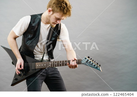 Man playing on electric guitar Man playing on electric guitar 122465404