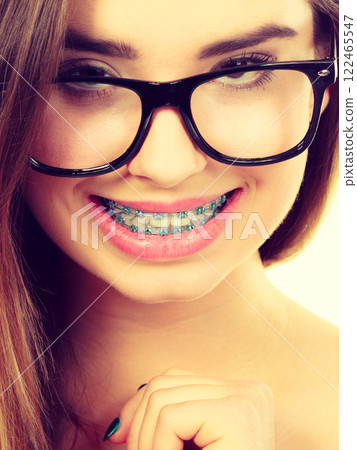 Happy nerdy teenage with brace wearing eyeglasses Happy nerdy teenage with brace wearing eyeglasses 122465547
