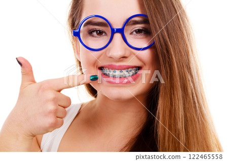 Nerdy woman showing her teeth with braces 122465558