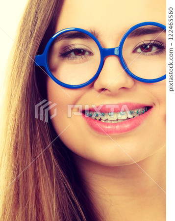 Nerdy woman showing her teeth with braces 122465560