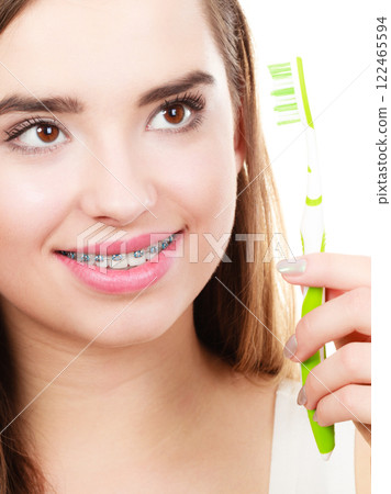 Woman holding toothbrush, thinking about hygiene 122465594