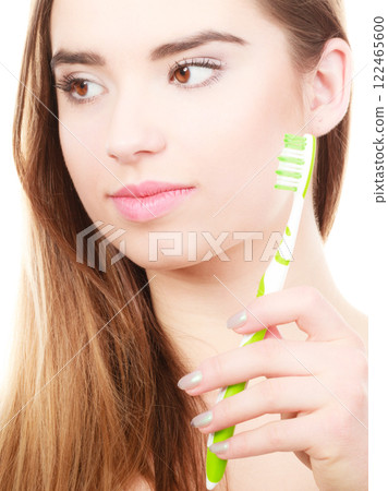 Woman holding toothbrush, thinking about hygiene 122465600