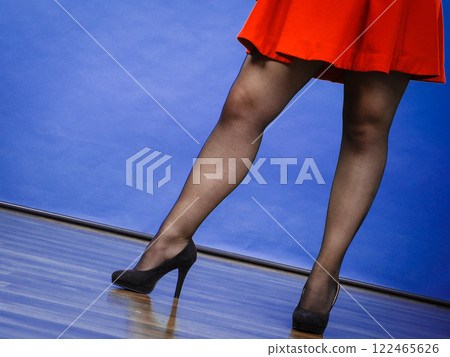Woman wearing red dress and high heels Woman wearing red dress and high heels 122465626