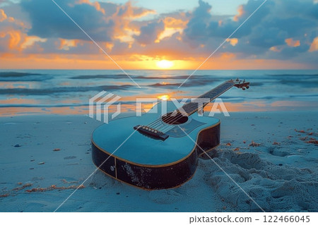 Blue guitar on sandy beach at sunset with ocean waves and colorful sky in background Blue guitar on sandy beach at sunset with ocean waves and colorful sky in background 122466045