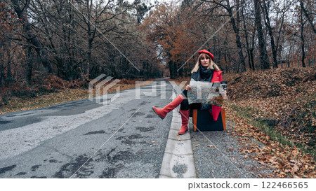 Woman with suitcase on the road Woman with suitcase on the road 122466565