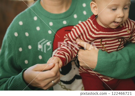 Joyful Holiday Moments Featuring a Baby Dressed in Colorful and Festive Sweaters Joyful Holiday Moments Featuring a Baby Dressed in Colorful and Festive Sweaters 122466721