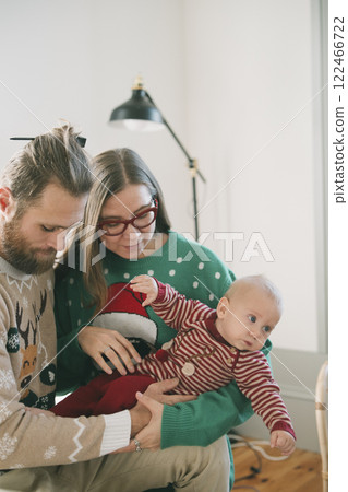 A Heartwarming Family Christmas Celebration with an Adorable Baby in Cozy Sweaters A Heartwarming Family Christmas Celebration with an Adorable Baby in Cozy Sweaters 122466722