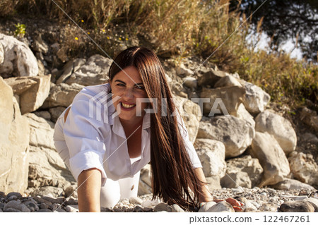 young pretty brunette woman on sea coast, lifestyle people concept young pretty brunette woman on sea coast, lifestyle people concept 122467261