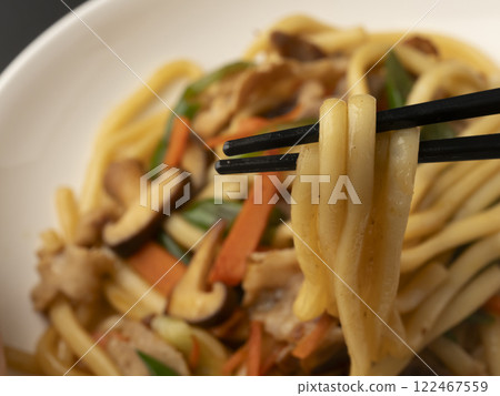 Pick up the fried udon noodles on a plate with chopsticks Pick up the fried udon noodles on a plate with chopsticks 122467559