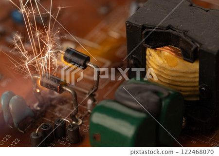 Sparks on Circuit Board Highlighting Fire Risks 122468070