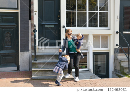 Mother and small children left the house for a walk or to kindergarten or school in Amsterdam. 122468081