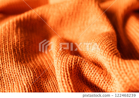 Close-up shot, hand-knitted in shades vivid orange.copy sapce Close-up shot, hand-knitted in shades vivid orange.copy sapce 122468239