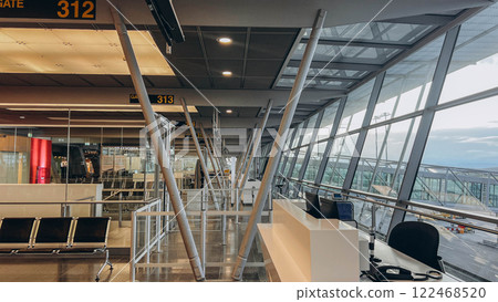 An empty terminal, aircrafts are waiting and preparing for their next flight and one of them taken off 122468520