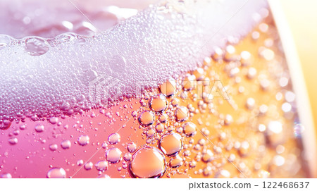 Colorful pink and yellow sparkling wine-like fizzy bubbles texture background 122468637