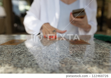 Woman using tarot cards at table . Astrological predictions 122468726