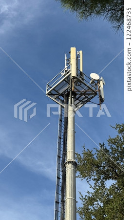 Cell tower with 5G antennas at blue sky 122468735