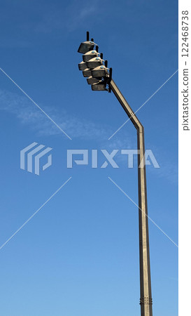 A high stadium floodlight against a clear blue sky. A high stadium floodlight against a clear blue sky. 122468738