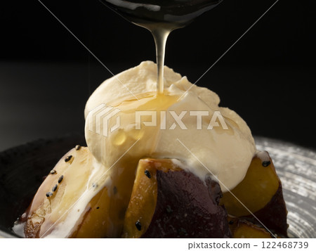 Put ice cream on hot candied sweet potato. Pour sauce over the candied sweet potato affogato. Put ice cream on hot candied sweet potato. Pour sauce over the candied sweet potato affogato. 122468739