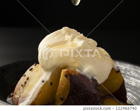 Put ice cream on hot candied sweet potato. Pour sauce over the candied sweet potato affogato. 122468740