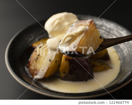Put ice cream on hot candied sweet potato and lift it up with a spoon. 122468774