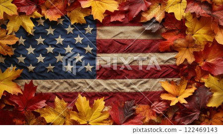 A red, white, and blue American flag is surrounded by a pile of orange leaves 122469143