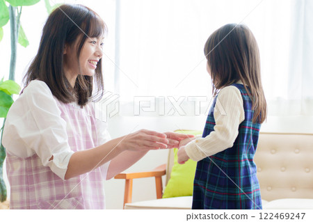 Nursery teacher playing with girls Nursery teacher playing with girls 122469247