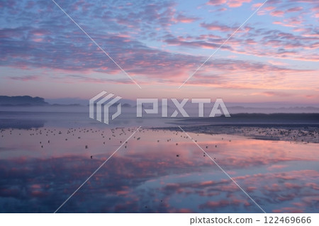 Serene Sunset Over Tranquil Lake 122469666