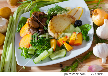 Chicken hearts in salad with roasted cheese, peach, pear 122470958