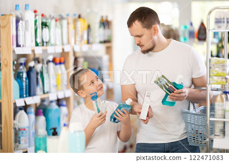 Buyers picked up oral care products and looking for gum care product in window Buyers picked up oral care products and looking for gum care product in window 122471083