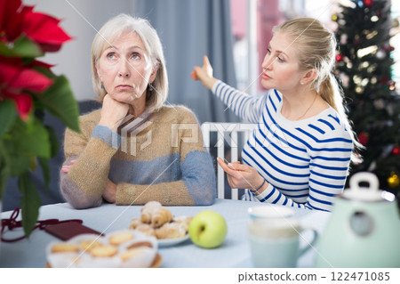 Daughter angry with elderly mother on Christmas night at home 122471085
