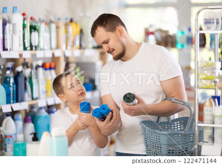 Man and boy choosing garbage bags in store Man and boy choosing garbage bags in store 122471144