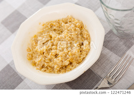 Boiled oatmeal porridge served in plate. Concept of diet food Boiled oatmeal porridge served in plate. Concept of diet food 122471246