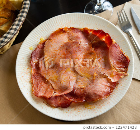 Slices of Lacon gallego with sweet paprika on plate Slices of Lacon gallego with sweet paprika on plate 122471428
