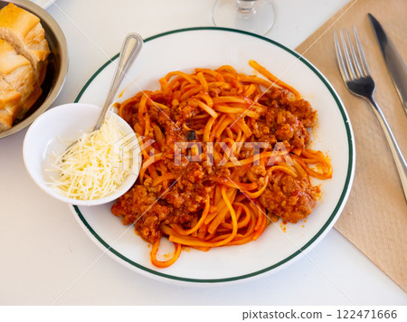 Delicious noodles Bolognese served in a plate on the table 122471666