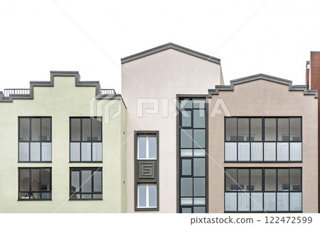 Contemporary residential building with geometric facade, glass windows, and balconies on bright sky background, urban architecture concept, front view Contemporary residential building with geometric facade, glass windows, and balconies on bright sky background, urban architecture concept, front view 122472599
