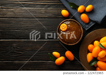 Kumquat on plate, bowl of jam and towel on wooden background, space for text Kumquat on plate, bowl of jam and towel on wooden background, space for text 122472965