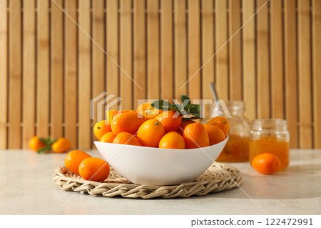 Kumquat in bowl and jars of jam on wooden background Kumquat in bowl and jars of jam on wooden background 122472991