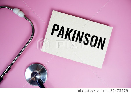 Pakinson text with stethoscope on pink background, Healthy and wellness concept 122473379