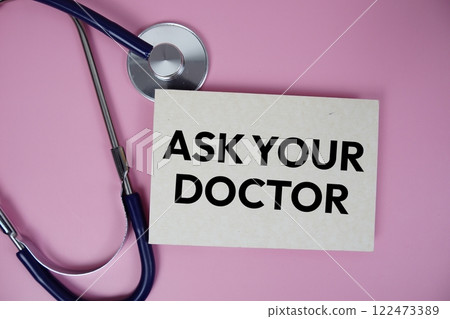 Ask Your Doctor text with stethoscope top view on pink background, Healthy and wellness concept 122473389