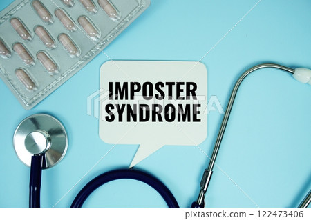 Imposter Syndrome text with stethoscope and capsule medicine on blue background, Healthy and wellness concept 122473406