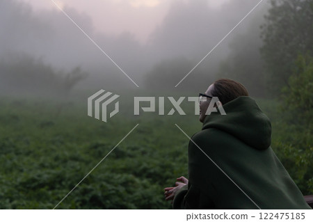 Captivating embrace of nature during a serene foggy morning in a lush green landscape Captivating embrace of nature during a serene foggy morning in a lush green landscape 122475185