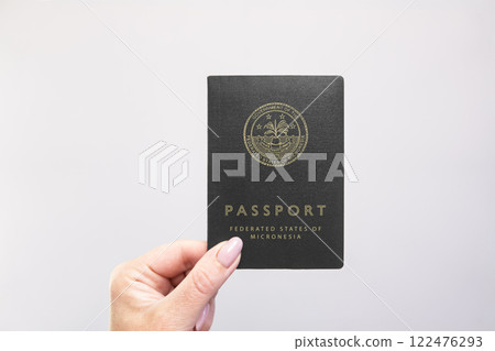 Passport Micronesia Held Against Simple White Background. Astana, Kazakhstan, 26 october 2024 Passport Micronesia Held Against Simple White Background. Astana, Kazakhstan, 26 october 2024 122476293