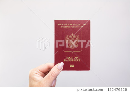 Passport Held Against Simple White Background. Astana, Kazakhstan, 26 october 2024 122476326