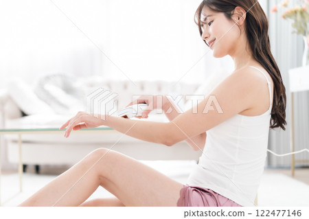 A young woman doing laser hair removal at home A young woman doing laser hair removal at home 122477146