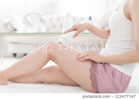 Young woman undergoing laser hair removal at home, no face 122477147